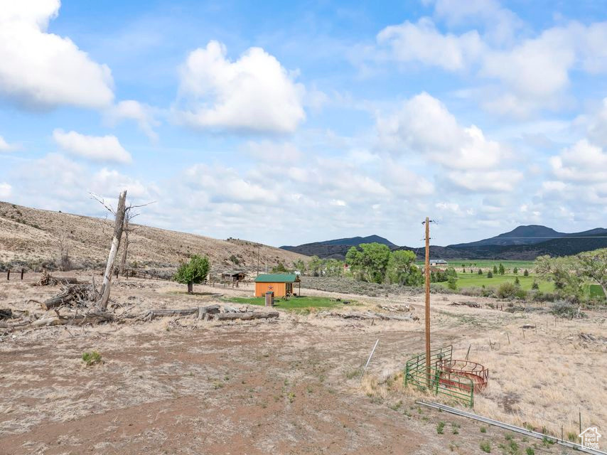 View of yard featuring a view of countryside, a mountain view, and an outdoor structure