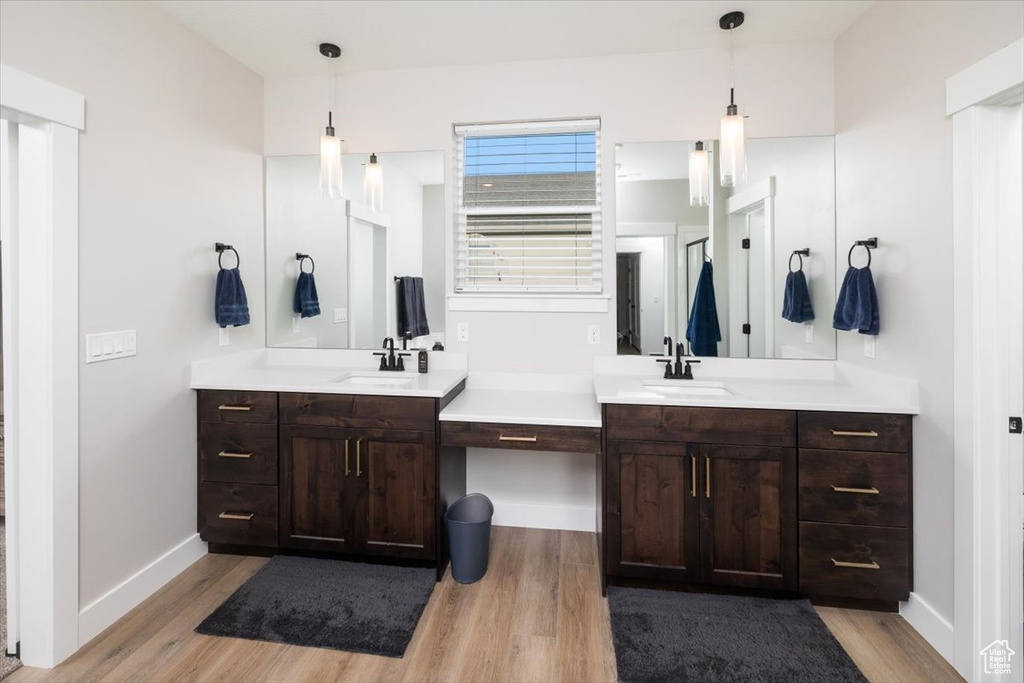 Bathroom with hardwood / wood-style floors and vanity