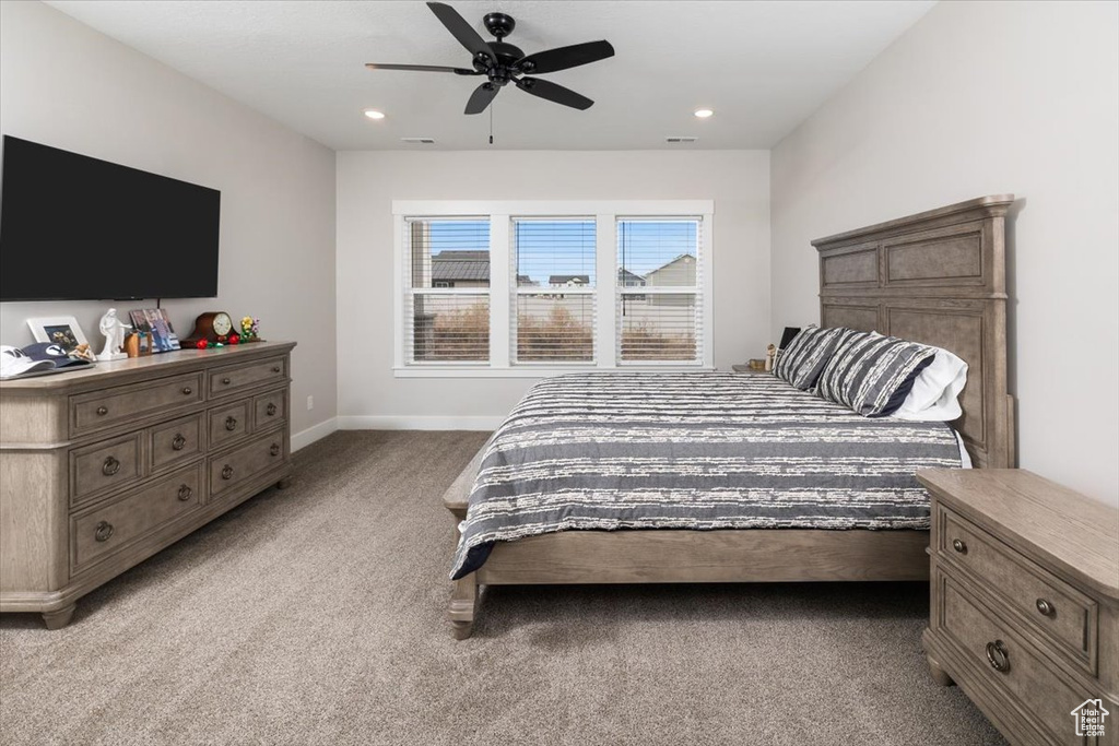 Bedroom with ceiling fan and carpet