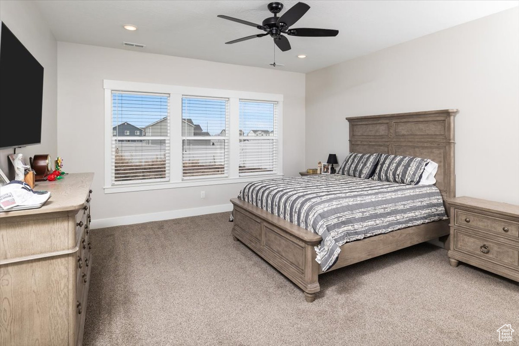 Carpeted bedroom with ceiling fan