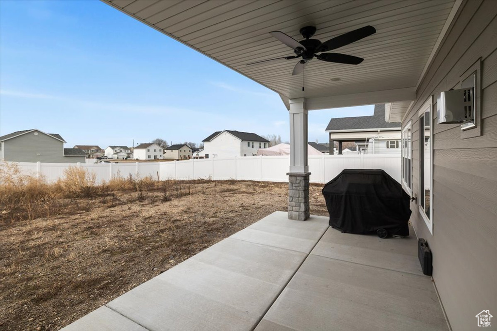 View of patio / terrace with ceiling fan and a grill