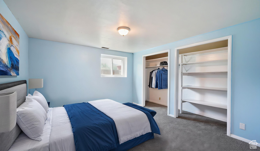 Carpeted bedroom with a closet and baseboards