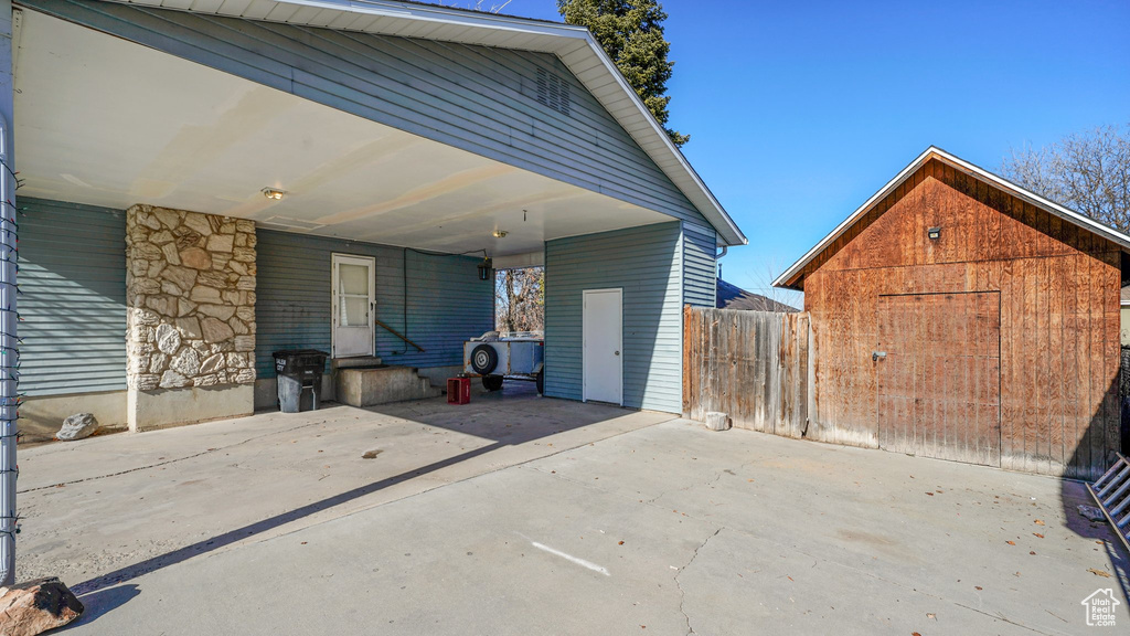 View of patio / terrace featuring a shed and a carport