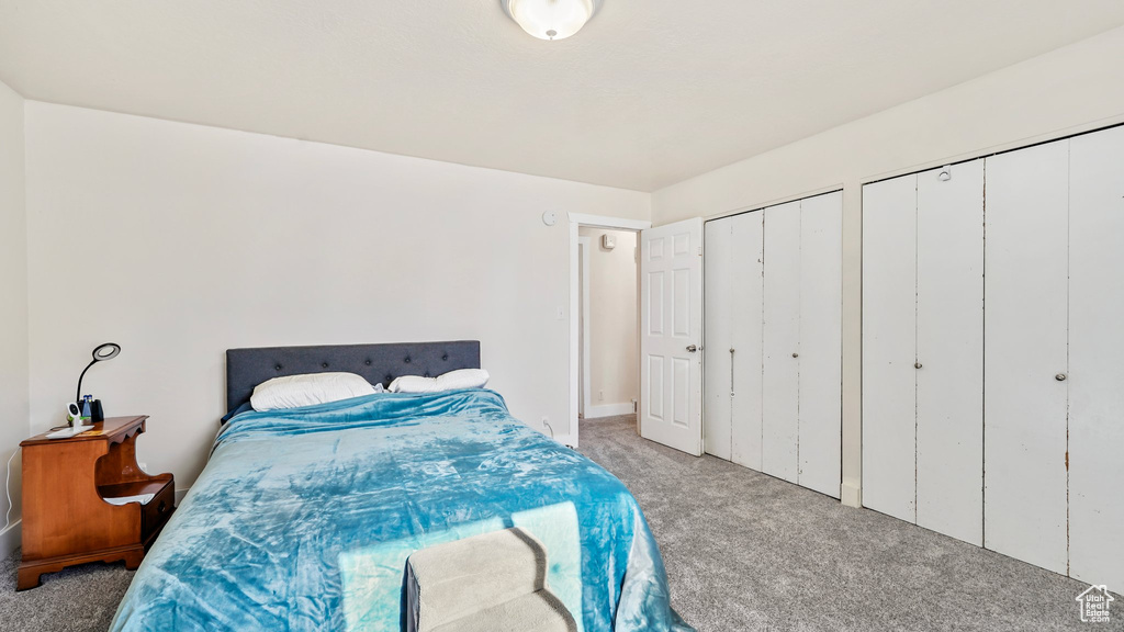 Carpeted bedroom with multiple closets