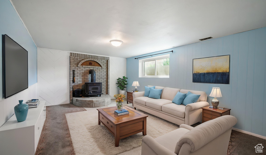 Living area with a wood stove and carpet