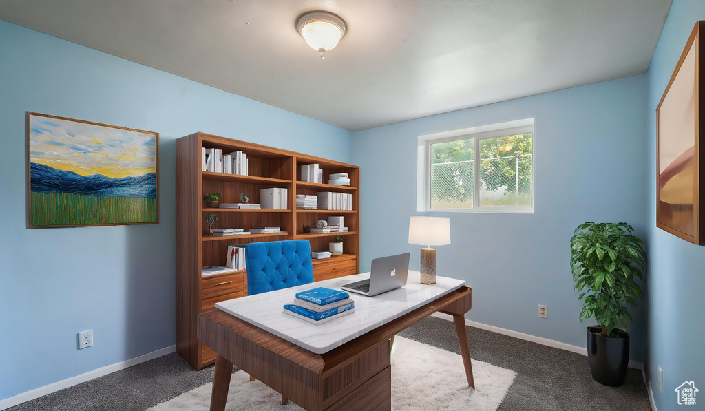Carpeted office space featuring baseboards