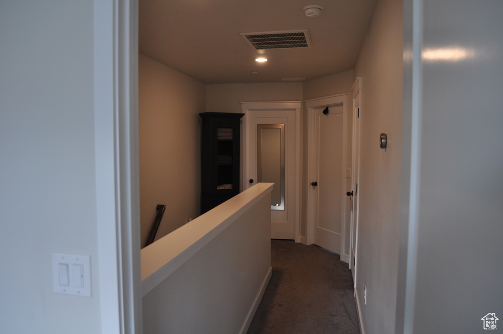 Hall featuring dark carpet