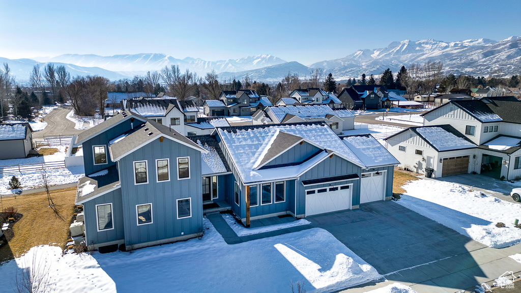 View of front of home featuring a mountain view and a garage