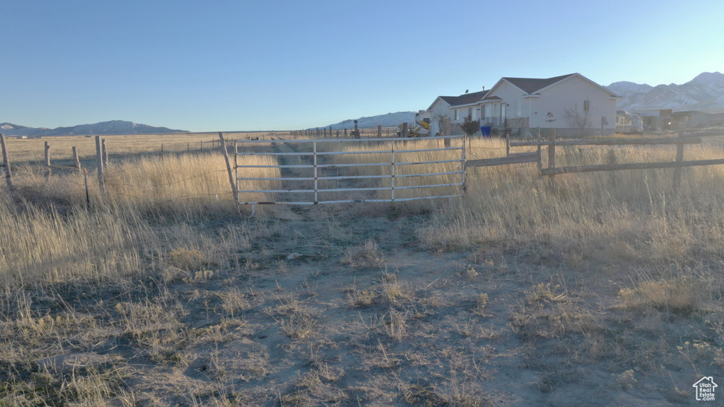 View of yard featuring a rural view and a mountain view
