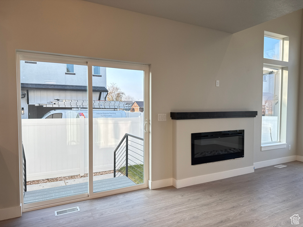 Unfurnished living room featuring hardwood / wood-style floors