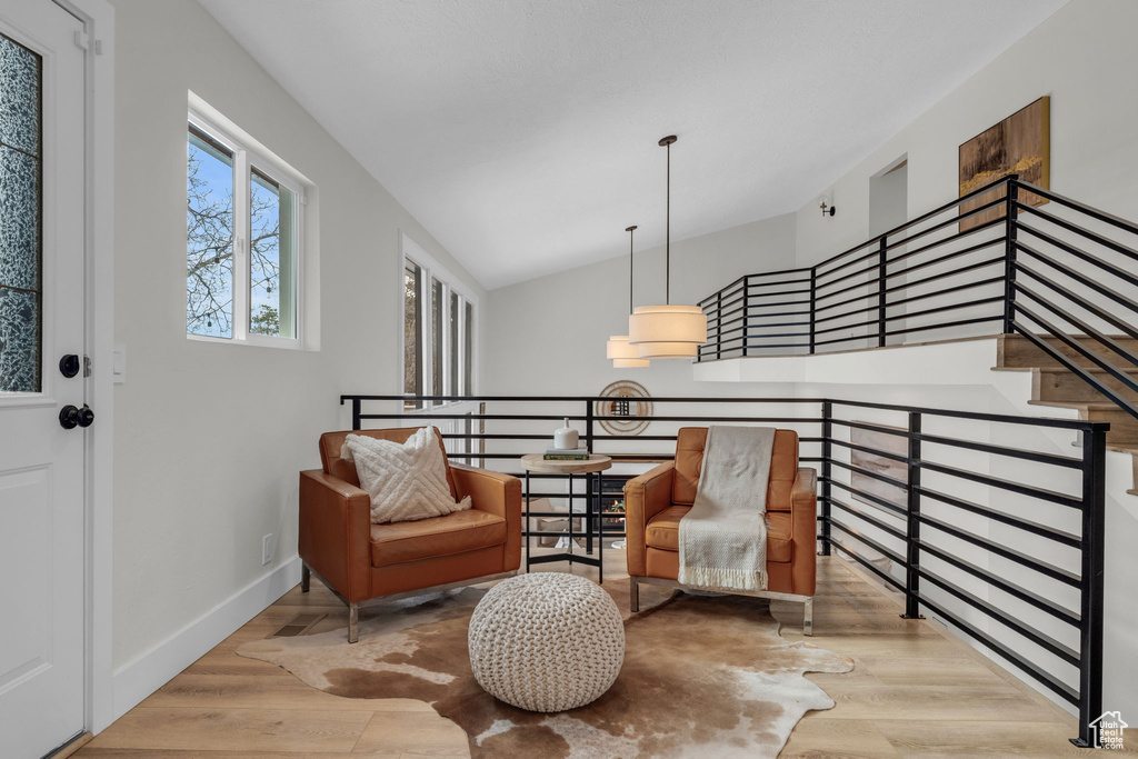 Living area featuring vaulted ceiling and light hardwood / wood-style floors