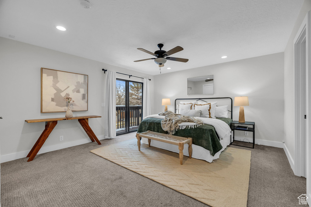 Carpeted bedroom featuring ceiling fan and access to outside
