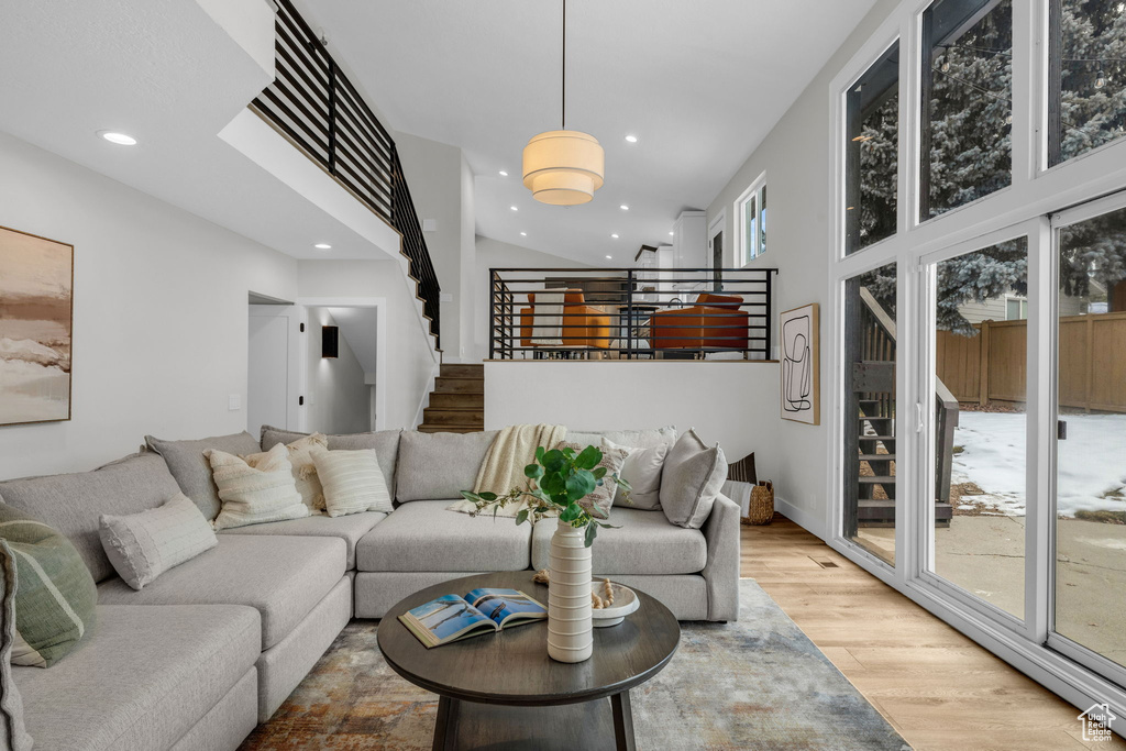 Living room featuring a towering ceiling and hardwood / wood-style floors