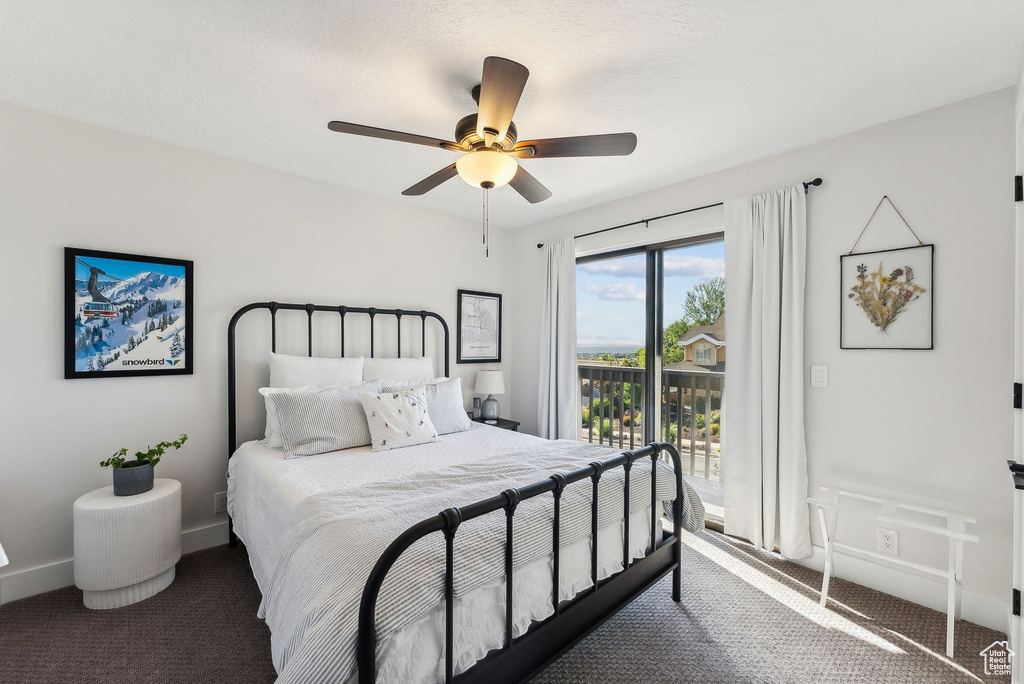 Carpeted bedroom with ceiling fan and access to outside