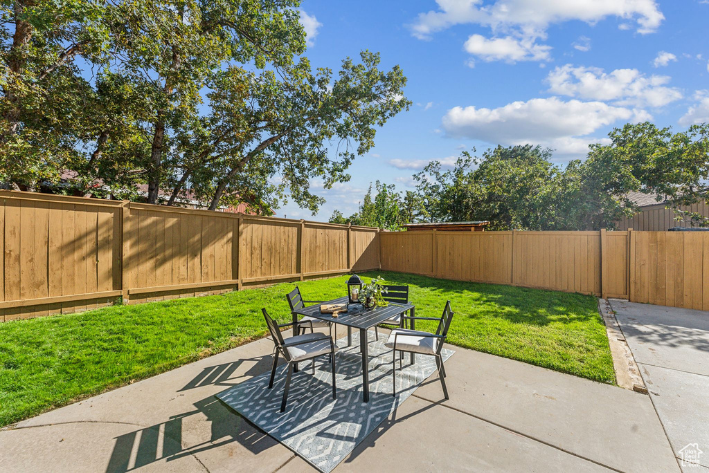 View of patio featuring outdoor dining area and a fenced backyard