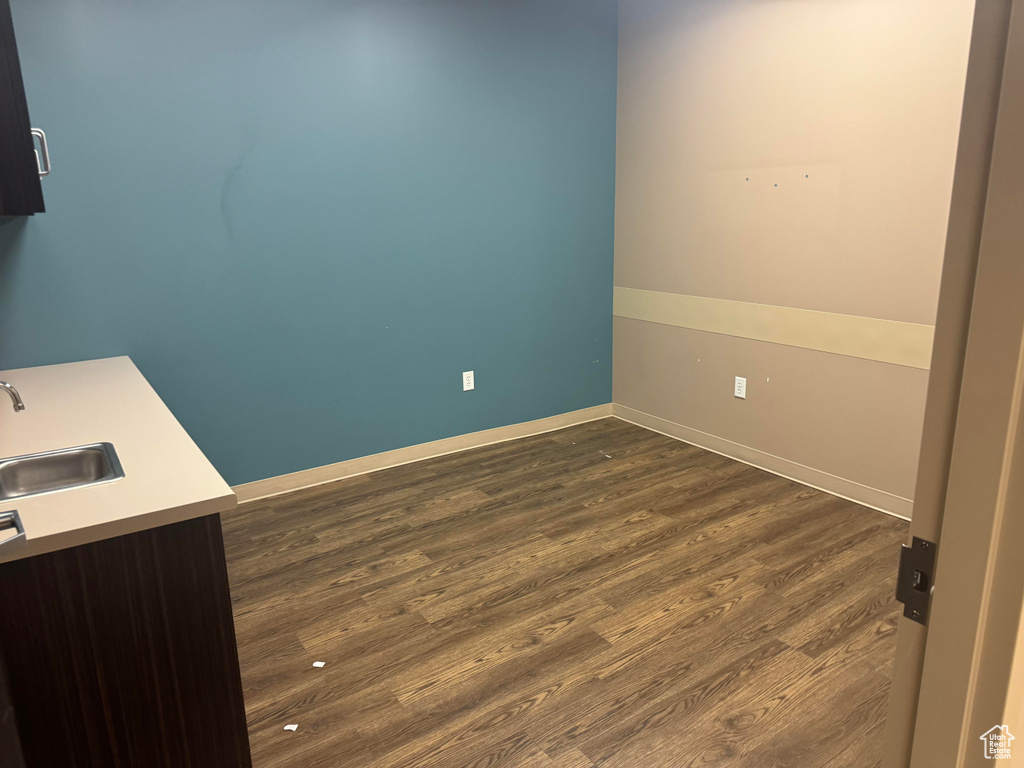 Interior space with dark hardwood / wood-style floors and sink