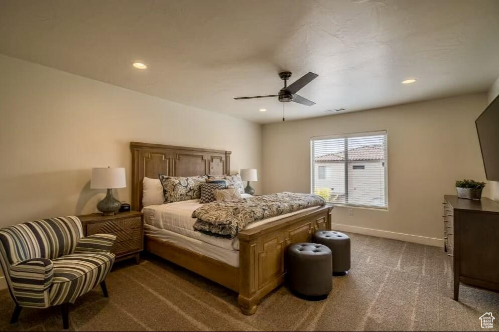 Bedroom featuring ceiling fan and carpet