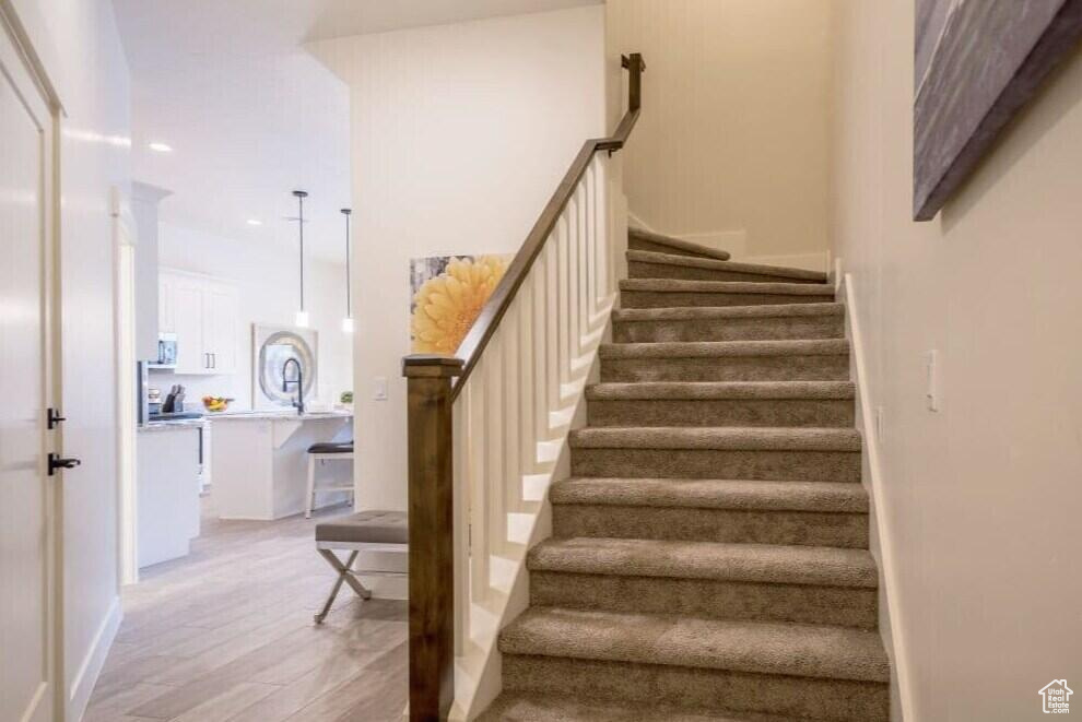 Stairway with hardwood / wood-style floors