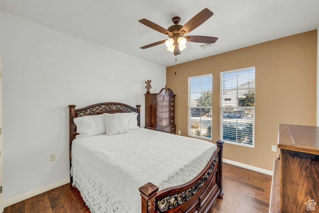 Bedroom featuring ceiling fan and dark hardwood / wood-style flooring