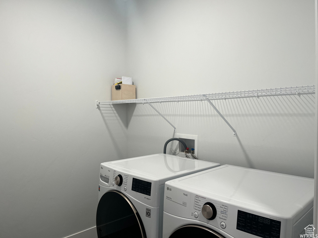 Washroom with washer and clothes dryer