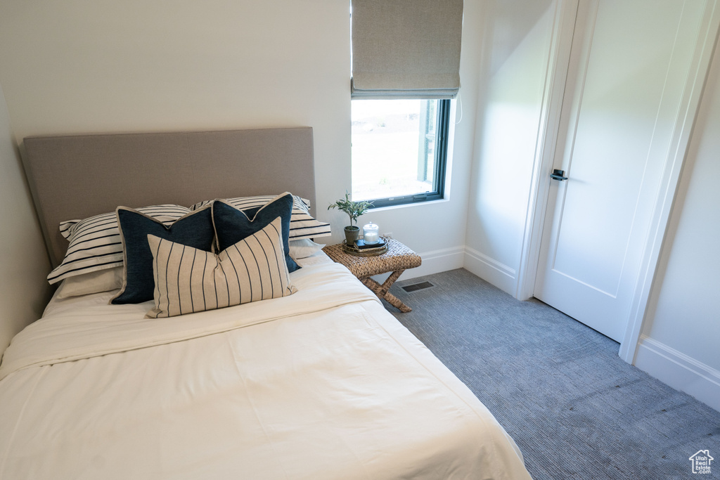Carpeted bedroom featuring baseboards