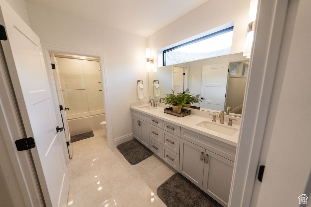 Bathroom with double vanity and shower / bath combination