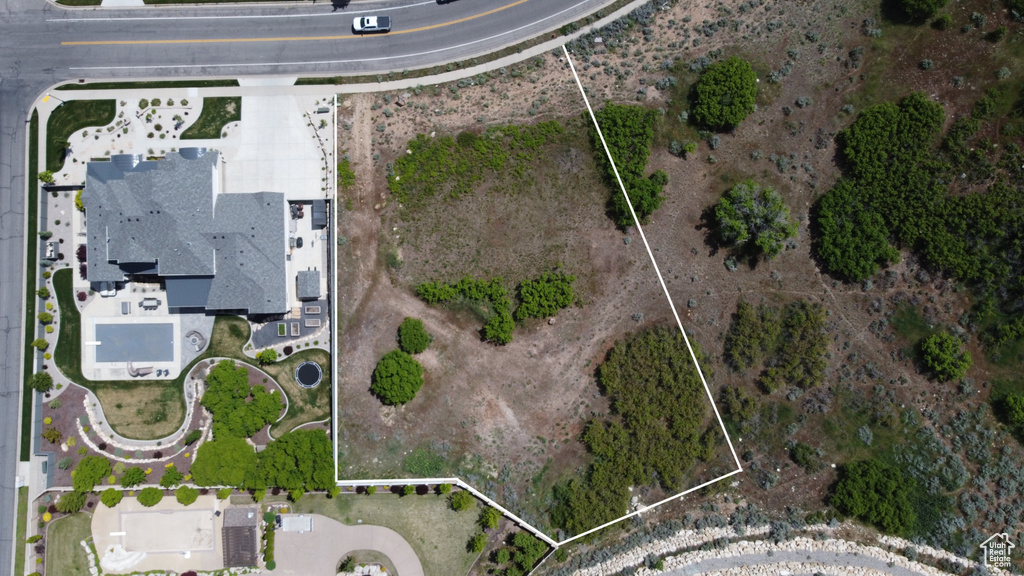 Aerial view of property and surrounding area featuring property parcel outlined