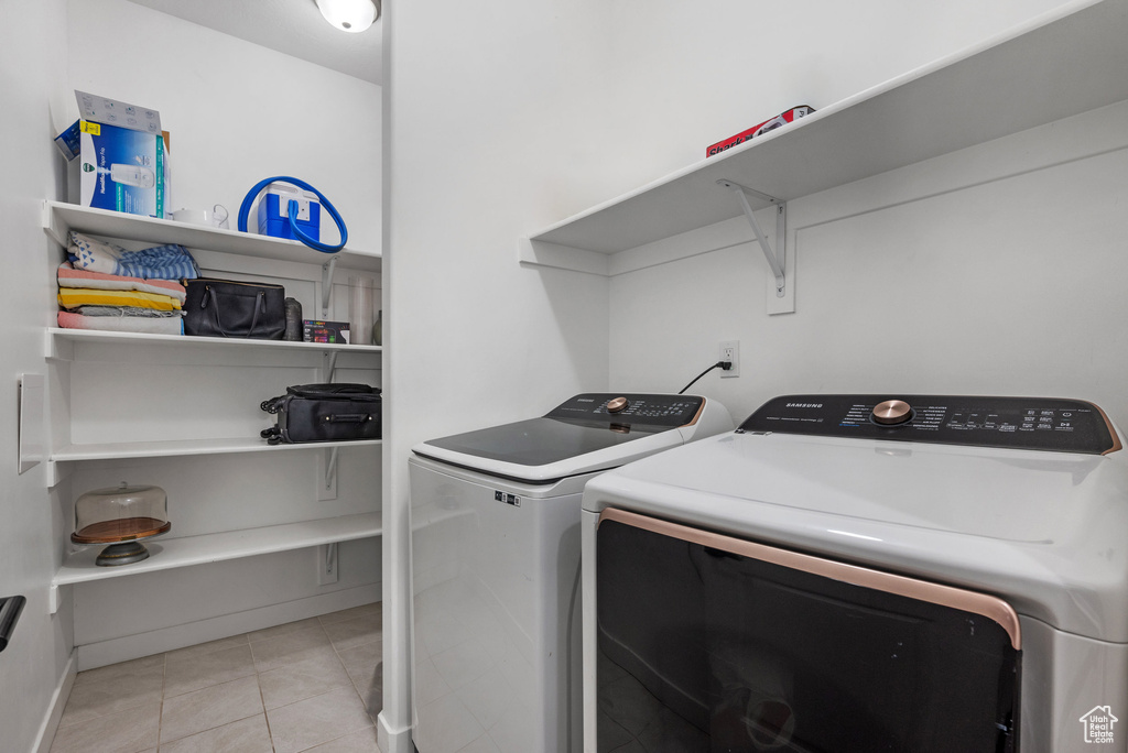 Laundry room featuring light tile patterned floors and washer and dryer