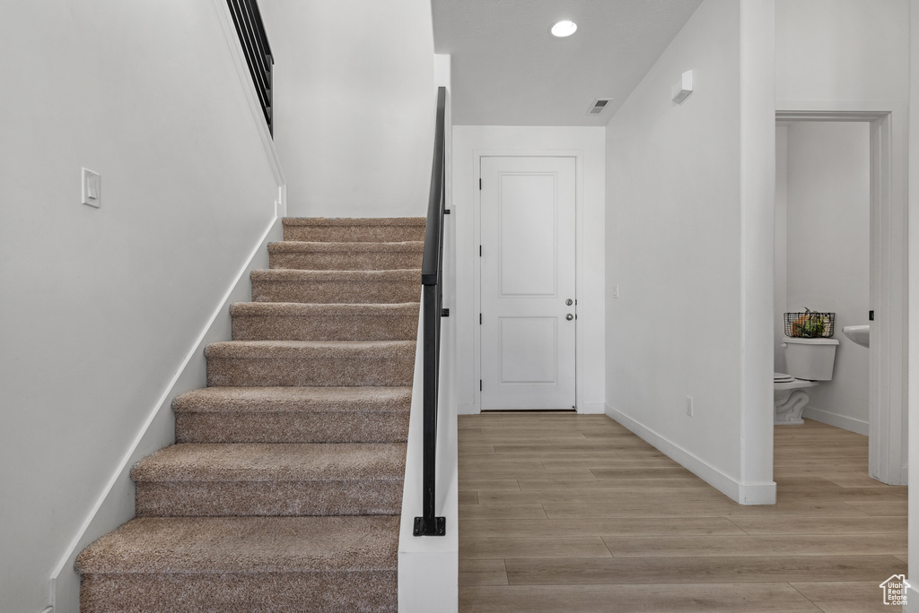 Staircase with hardwood / wood-style flooring
