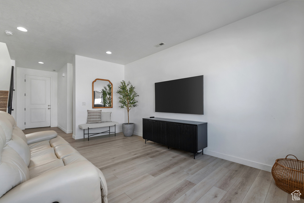 Living room with light hardwood / wood-style floors
