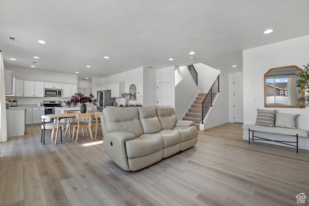 Living room with light hardwood / wood-style floors