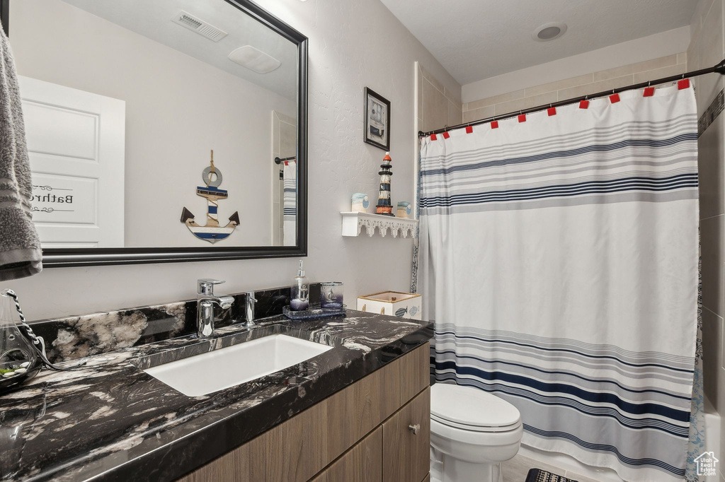 Bathroom featuring vanity and toilet