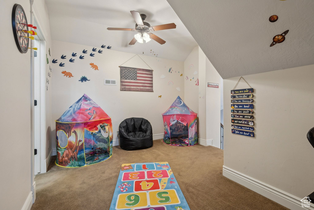 Rec room featuring ceiling fan and carpet floors