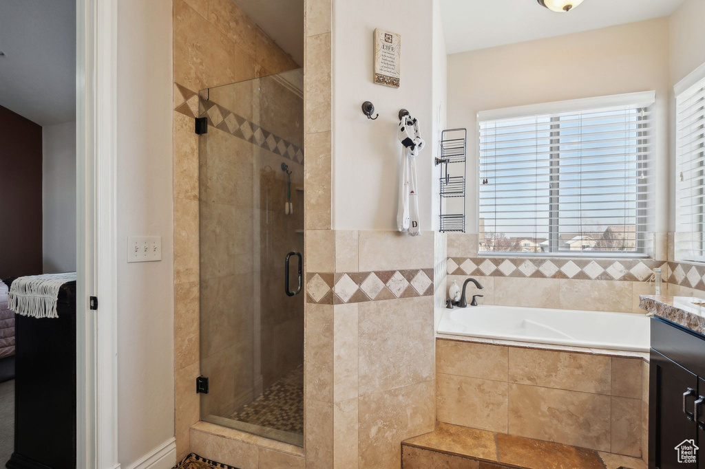 Bathroom with vanity and plus walk in shower