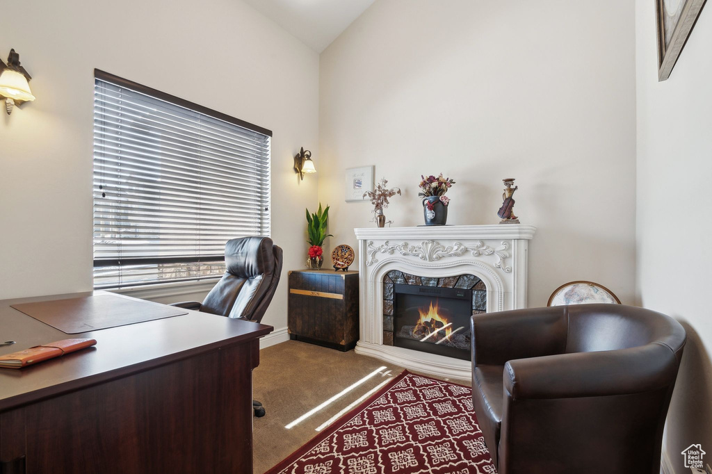 Office area featuring vaulted ceiling and a high end fireplace