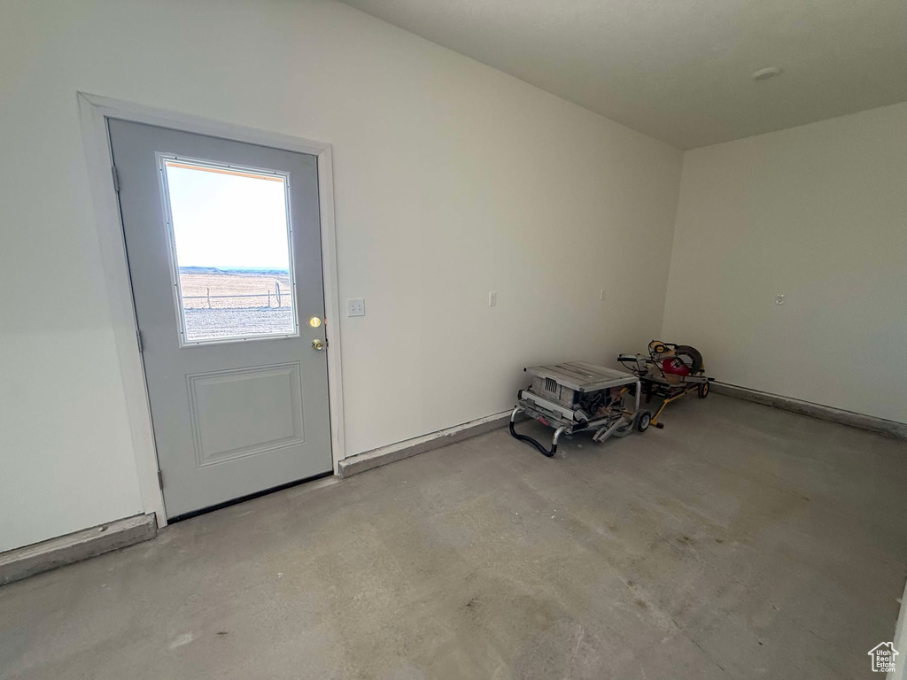 Doorway to outside featuring concrete flooring