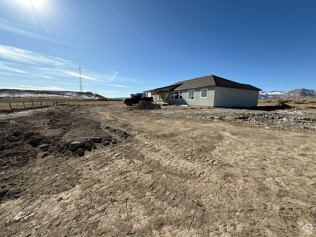 View of yard with a rural view and a mountain view