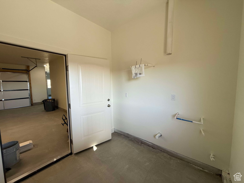 Washroom featuring a garage and baseboards