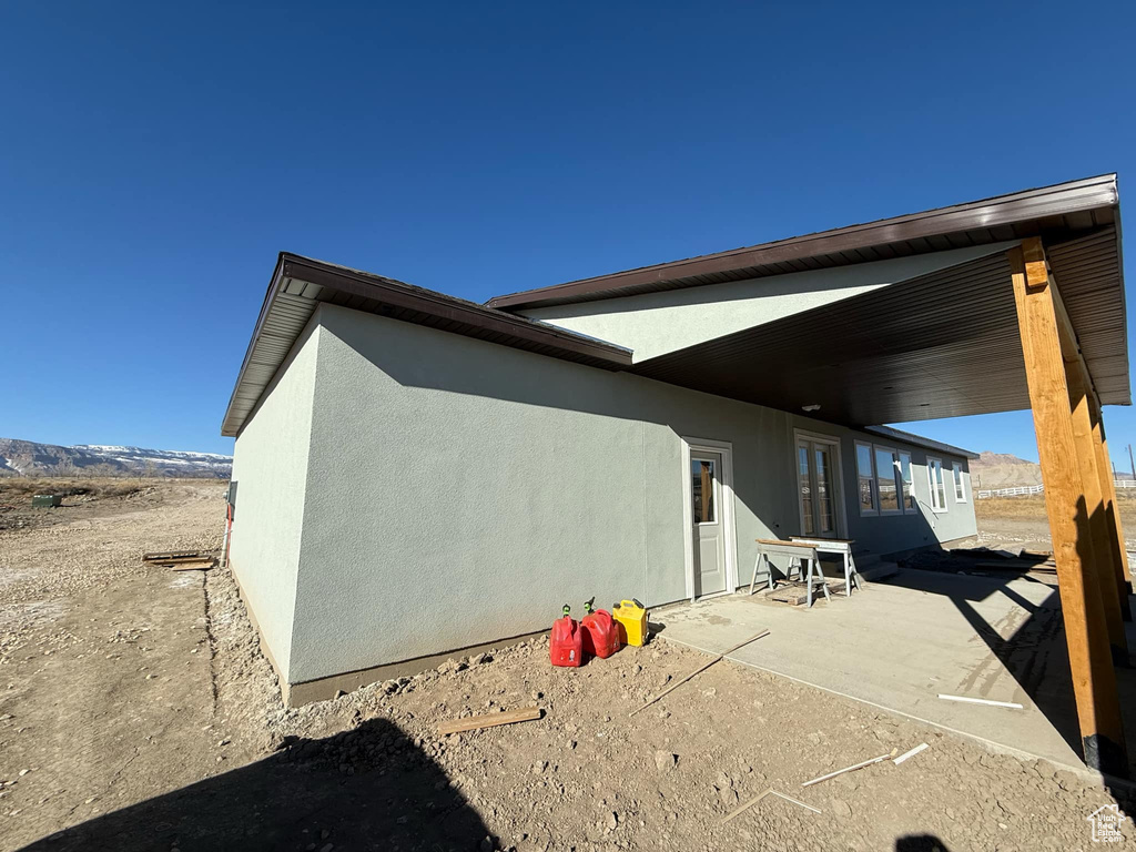 View of side of home featuring a patio