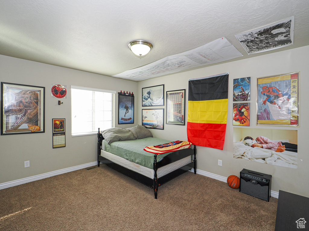 Carpeted bedroom featuring a textured ceiling