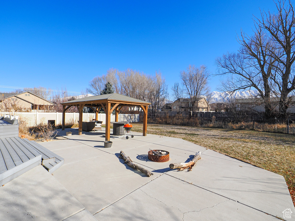 View of patio / terrace featuring an outdoor fire pit and a gazebo