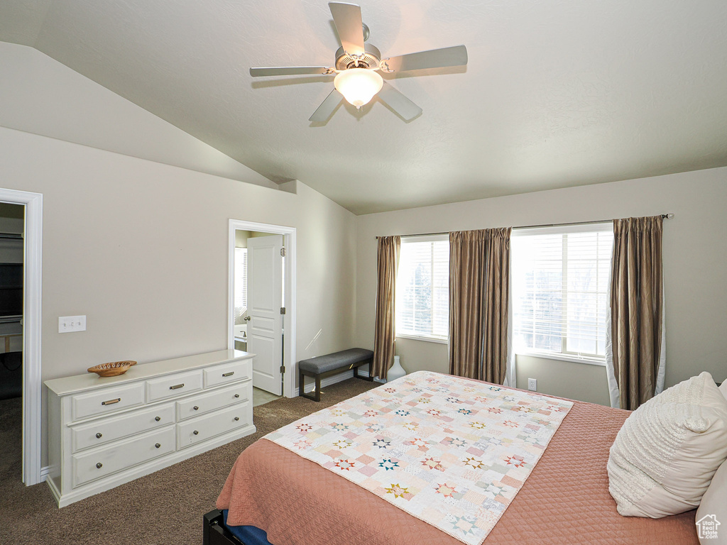 Carpeted bedroom featuring lofted ceiling and ceiling fan