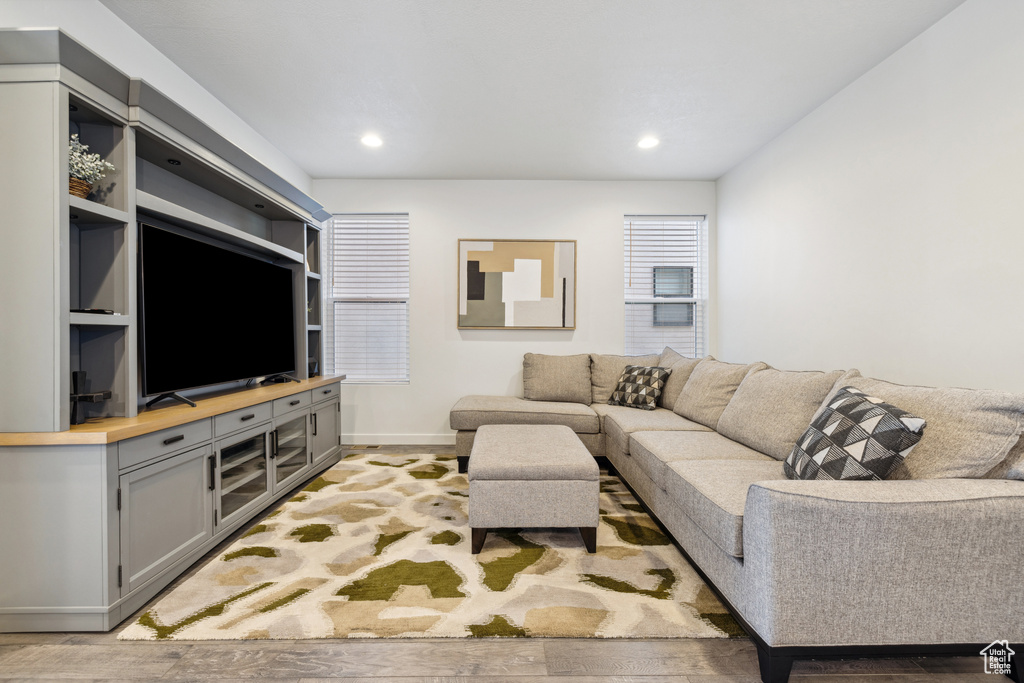 Living area with baseboards, light wood-type flooring, and recessed lighting