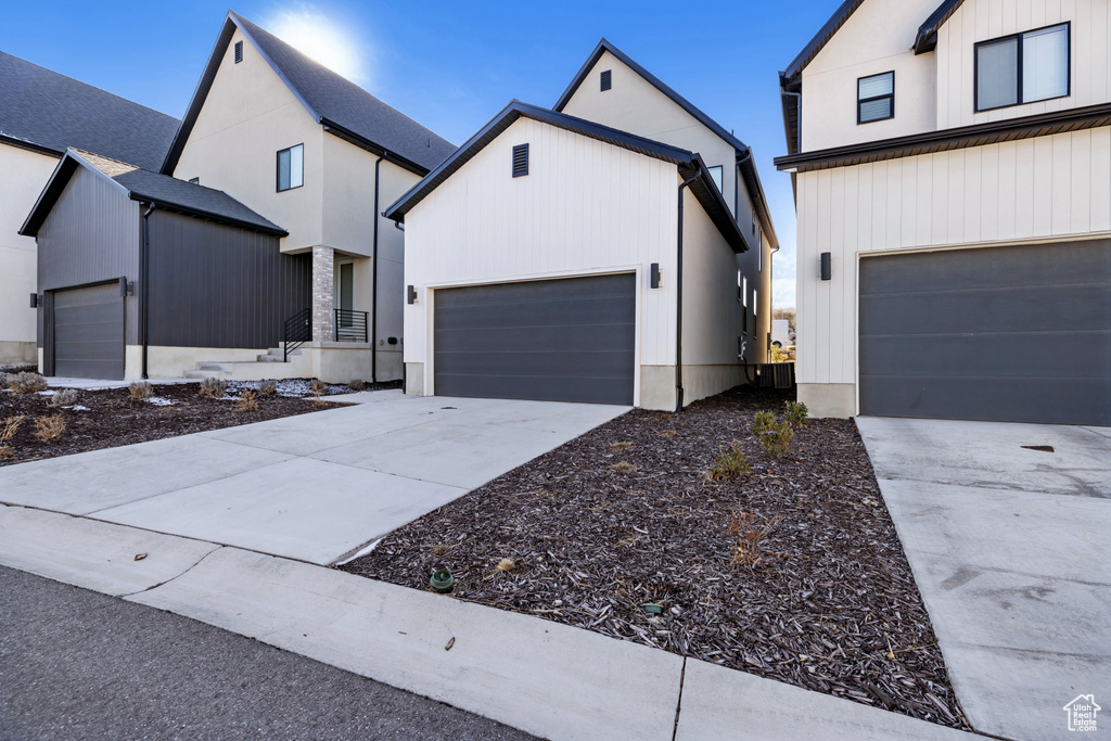 Modern farmhouse with concrete driveway