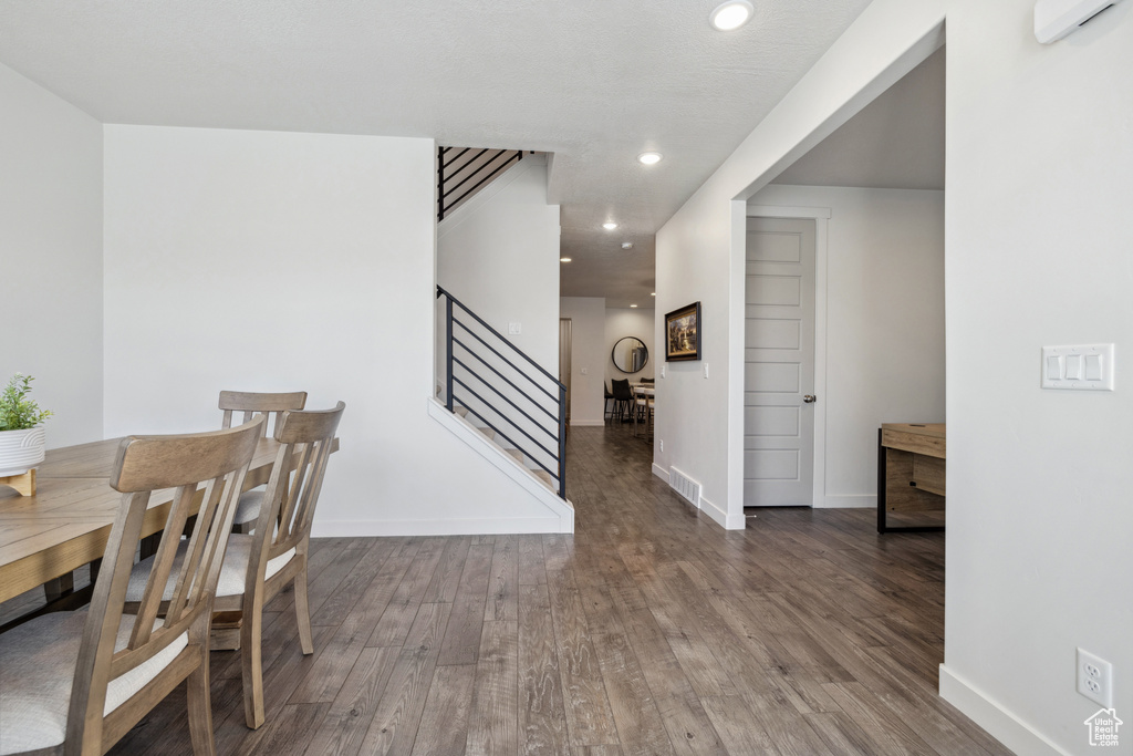 Dining space featuring recessed lighting, stairway, baseboards, and wood finished floors