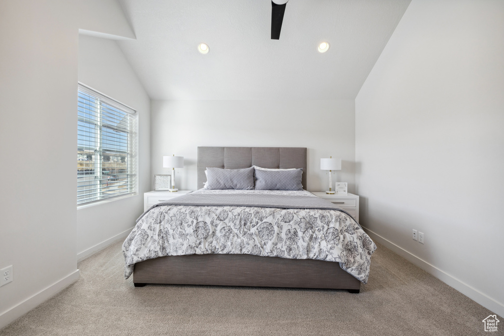 Carpeted bedroom with vaulted ceiling, ceiling fan, recessed lighting, and baseboards