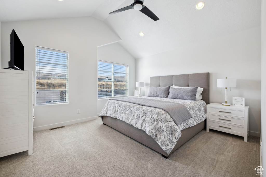 Carpeted bedroom with lofted ceiling, recessed lighting, visible vents, a ceiling fan, and baseboards