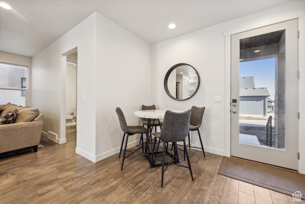 Dining room with recessed lighting, visible vents, baseboards, and wood finished floors