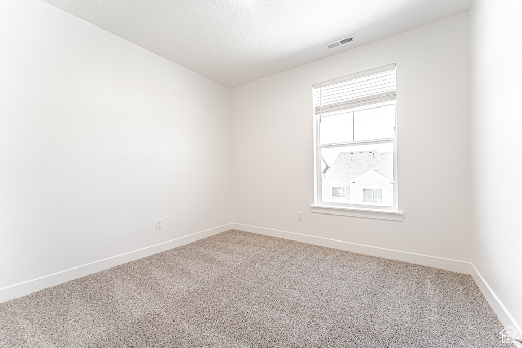 Unfurnished room with carpet and baseboards