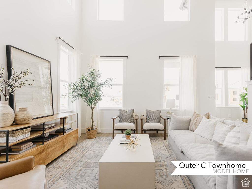 Living room featuring light hardwood / wood-style floors and a towering ceiling
